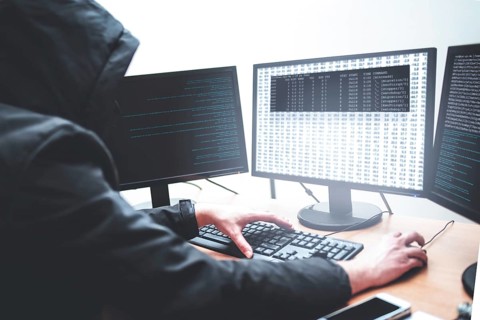 Hack concept. Picture of male hacker trying to steal information from system while looking at