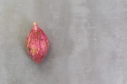 Great concept of healthy eating, sweet potato on gray background, polished concrete
