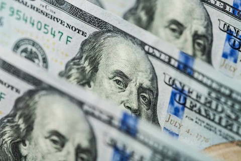 Hundred dollars bills standing in a row. Selective focus