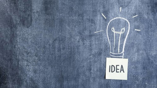 Idea text hand drawn light bulb blackboard
