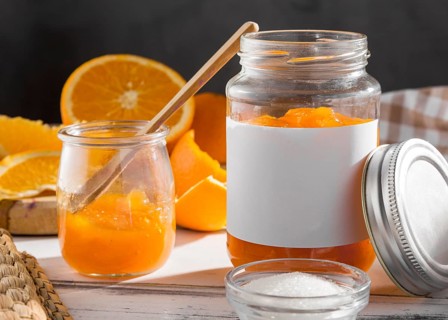 Front view transparent jar with orange jam