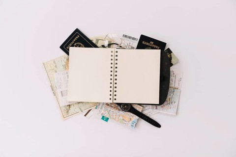 Overhead view blank spiral notebook passport map isolated white background