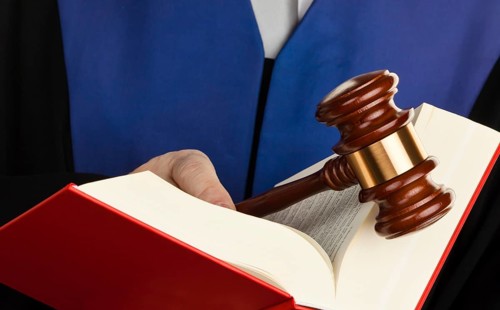 A judge with a law book in court. Gavel in hand, A judge with a law book in court. Gavel in hand.