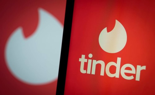 tinder logo is seen on a smartphone