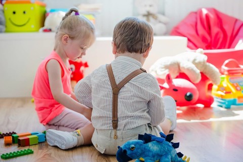 Children sitting floor playroom