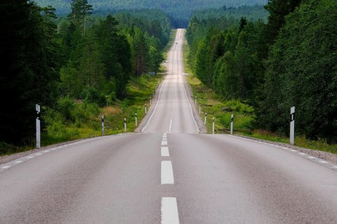 Lonely country road through forest, Värmland, Sweden, Europe