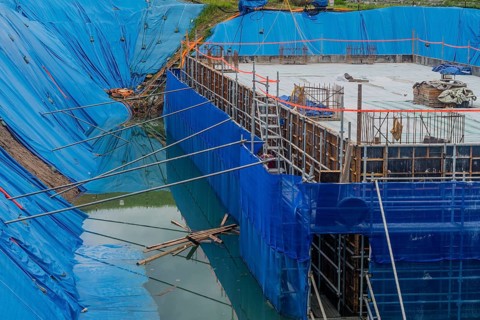 Daejeon, South Korea, August 9, 2020: Foundation for building under construction surrounded by high