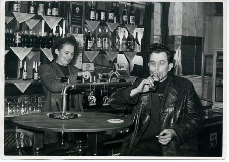 Pub, landlady, man drinking beer at the bar, smoking, 1960s, Germany, Europe