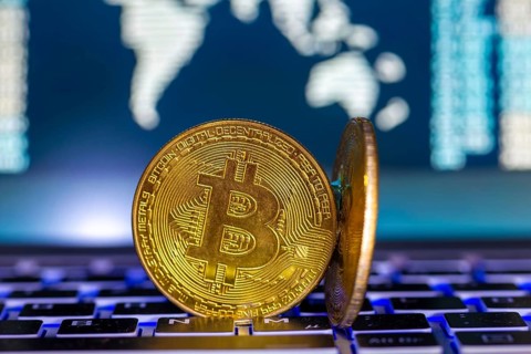 Symbolic bitcoins on a laptop