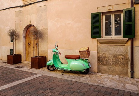 Green Vespa in the old town of Santanyi, Majorca, Balearic Islands, Spain, Europe