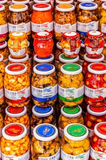 Vegetables in jars on a stall at the Whitsun market in Portoferraio, Elba Island, Tuscan