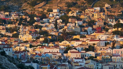 Villas spread over hills, warm light of the rising sun, picturesque and quiet, Symi Town, Symi,