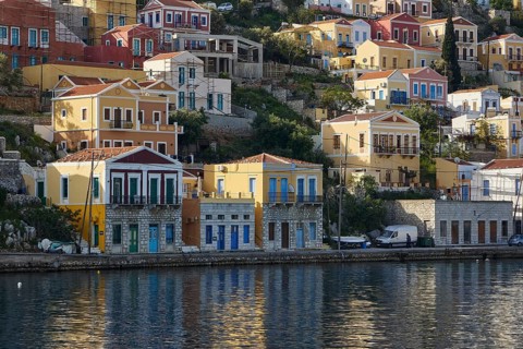Colourful houses on the shore with water view, Symi Town, Symi, Dodecanese, Greek Islands, Greece,
