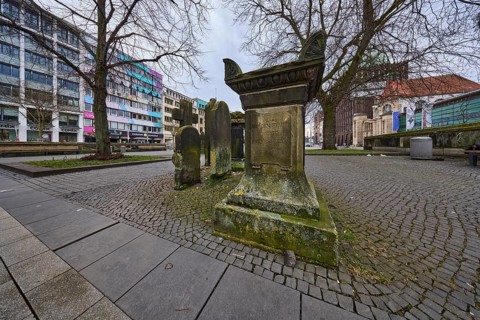 Historic gravestones, general architecture, pavement made of cobblestones and paving slabs, diffuse