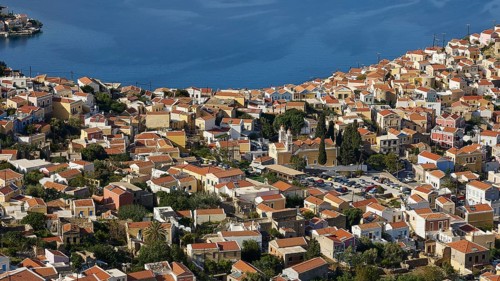 Dense cluster of houses overlooking the sea beyond, Symi Town, Symi, Dodecanese, Greek Islands,