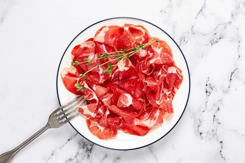 Plate with sliced cured meat, pork neck, prosciutto coppa, Italian delicacy