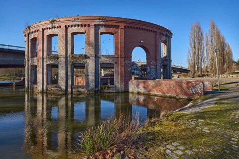 Park, pond, artificial ruin, trees, car and pedestrian bridge, symmetrical reflections, water