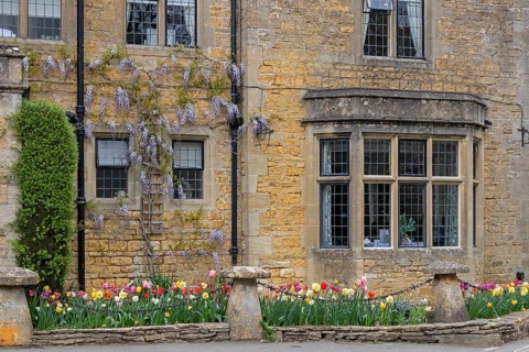Honey-coloured house, windows, flowers, Bourton-on-the-Water, The Cotswolds, Gloucestershire,