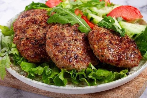 Fried cutlets, mixed minced meat, with vegetable salad, homemade, top view, no people