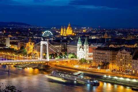 Evening panorama of Budapest with the Danube and the Elisabeth Bridge. The illuminated church in