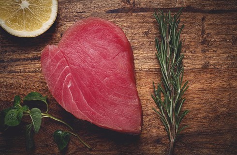 Fresh red tuna fillet, for steak, raw, top view, on a cutting board, no people