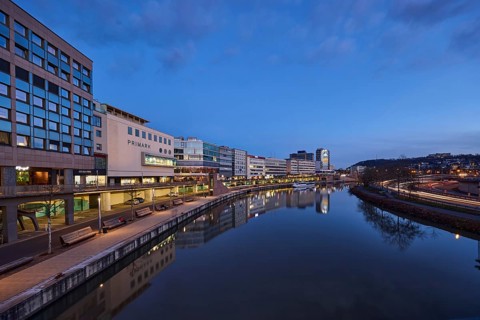 River Saar, modern architecture, trees, fashion shop, Primark, reflections on the water surface,
