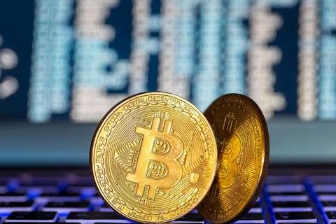 Symbolic bitcoins on a laptop