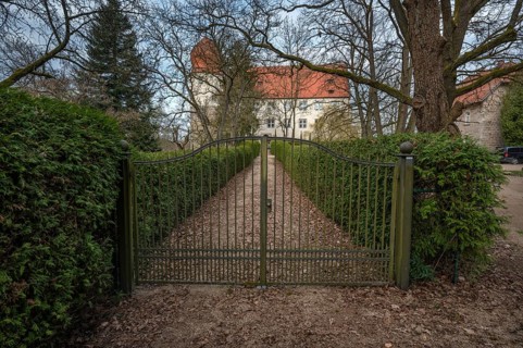Moated castle with entrance gate, originally a manor house, converted into a Renaissance castle