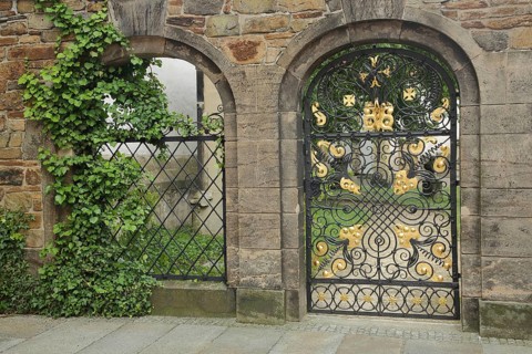 Metal door with golden decorations to the cemetery, churchyard, metal grille, two, wrought iron