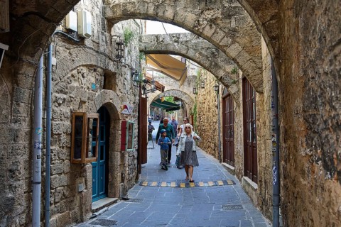 Narrow alley with archway in the old town, surrounded by stone walls, Rhodes Old Town, Rhodes,