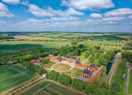 Aerial view of Bothmer Castle, a baroque three-winged complex. The castle stands on a rectangular