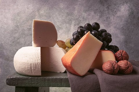 Georgian cheese, Imeretian and smoked suluguni, grapes, nuts, on a cutting board, Georgian cuisine,