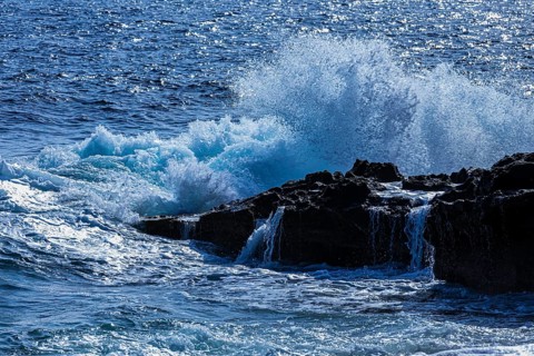 Rugged rocky coastline and foaming spray, on Stecci beach, near Capoliveri, Elba Island, Tuscan