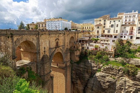 The imposing Puente Nuevo bridge in Ronda, which crosses a deep ravine, surrounded by historic