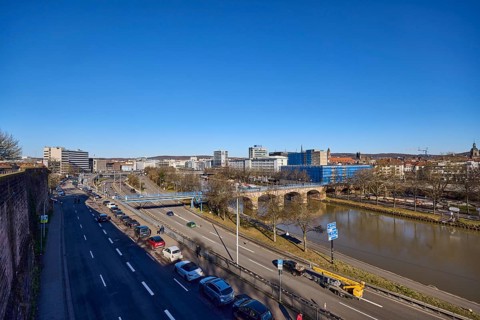Long shot, river Saar, streets, cars, pedestrian bridge, trees, parking strip with vehicles, river