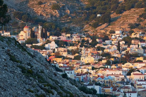 A picturesque hilltop village with traditional stone houses and a summery atmosphere, Symi Town,