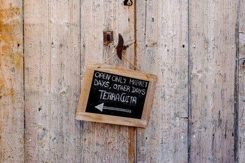 Wooden door with small slate plaque in the old town of Santanyi, Majorca, Balearic Islands, Spain,