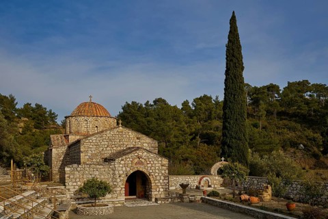Stone church with cypress in front of a wooded background, Monastery Thari, Moni Thari, near
