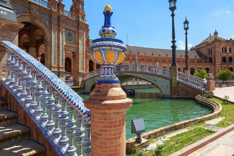 Close-up of a tiled bridge at the Plaza de España in Seville with water in the background, Seville,