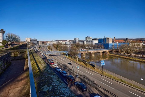 Long shot, castle fortification, river Saar, streets, cars, pedestrian bridge, trees, parking strip