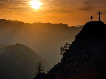 Mountaineers at the summit cross of the Kleiner Jenner at sunset, Reiteralpe in the background,