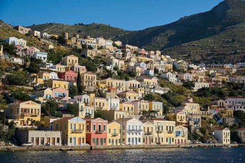 Colourful houses on a hilly shore, Symi Town, Symi, Dodecanese, Greek Islands, Greece, Europe