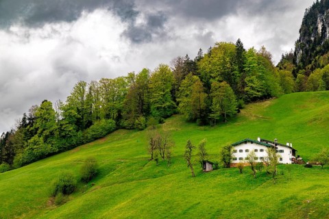 Old farmhouse in Maria Gern under dark clouds, Berchtesgaden, Berchtesgadener Land, Upper Bavaria,