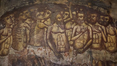 An oppressive scene in a fresco with skeletons and suffering figures in a cramped crowd situation,