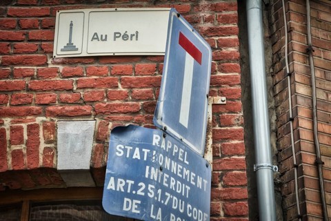 Liege, Belgium, June 2021: Street sign of Au Peri in Liege on a brick wall. Close-up and detail,