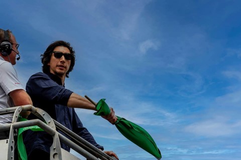 Honorary starter, Adam Driver, prepares to drop the green flag for the Indianapolis 500 in