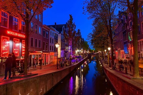 Night view of De Wallen, the famous red-light district with window prostitution in Amsterdam,