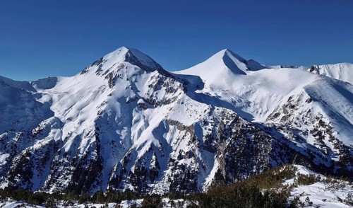 Beautiful Pirin mountains peaks covered with snow. Winter view at Bansko ski resort in Bulgaria