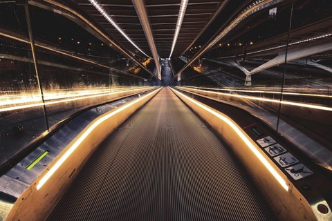 Symmetrical escalator with illuminated handrail in modern surroundings, Liège-Guillemins railway