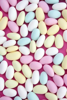 Sugared almond sweet candy pastel colorful on soft pink